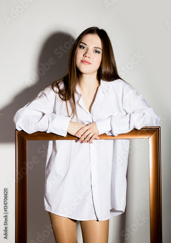 Naked Girl In A Man S White Shirt Holding Wooden Frame Stock Photo