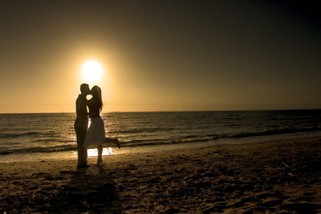 couple kissing at beach