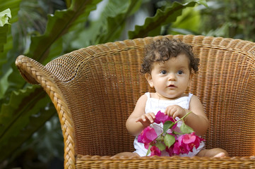 infant and orchid in chair