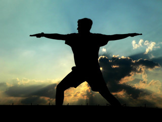 silhouette of man practicing yoga