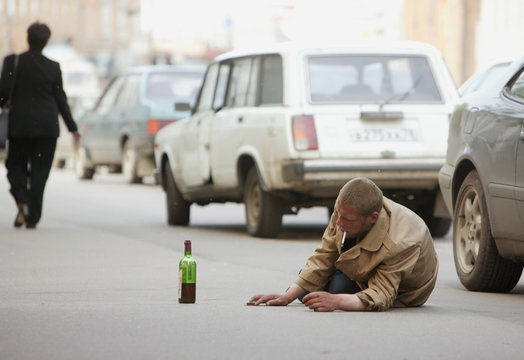 alcoholic lies on the road