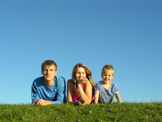 family on herb under blue sky