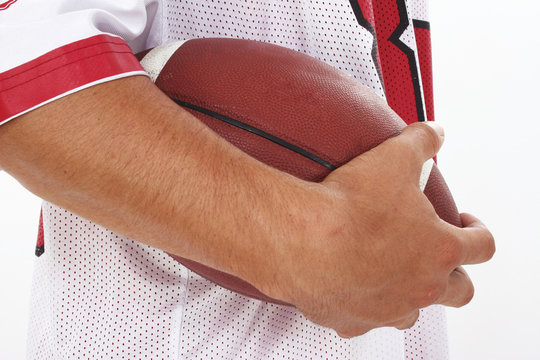 Close Crop Of Man In Jersey Holding Football