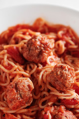spaghetti and meatballs in shallow dish