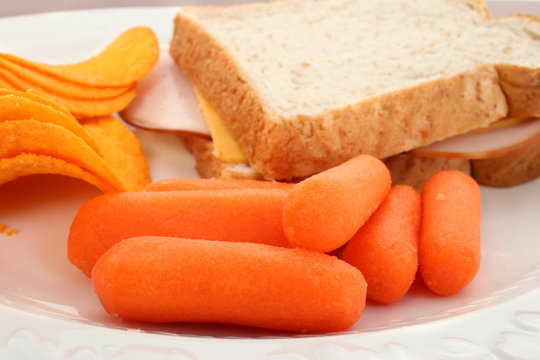 close up of baby carrots on lunch plate