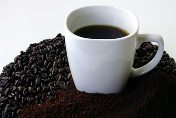 a mug of coffee surrounded by coffee beans