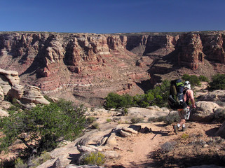 backpacker heading into dark canyon