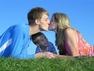 Obraz premium parent's kiss and son