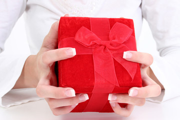 hands holding red velvet gift box