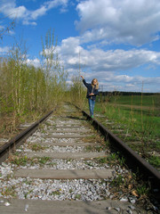 Fototapeta na wymiar girl balancing on rail