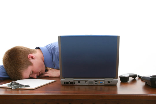 Young Man Asleep At Desk