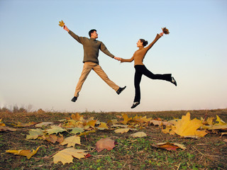 jump couple autumn leaves