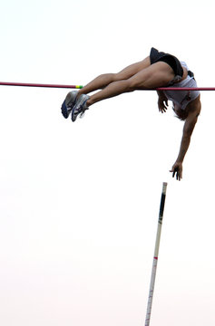 athlete clearing the bar