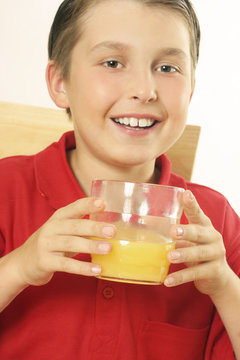 a child drinking orange juice