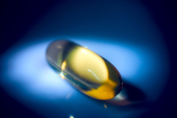 gold pill on blue background