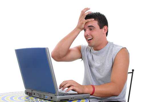 attractive young man working on laptop computer