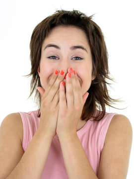 girl laughing with her hands over her mouth
