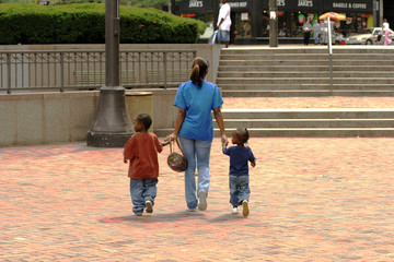 mother and two childeren walking holding hands