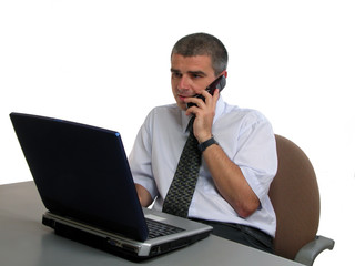 man speaking to the phone at the office desk