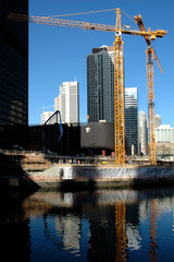 double construction cranes & reflection