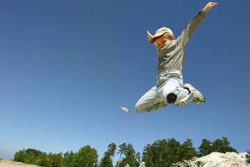 jumping boy on the spring beach