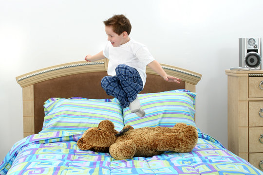 Cute Boy Jumping In Bed