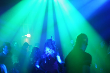 young female dancer in/between beams of light