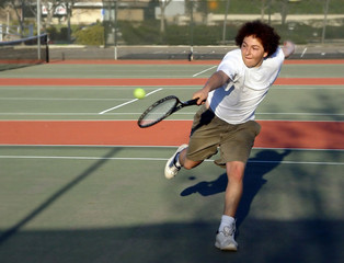 teenage boy playing tennis