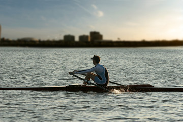 rowing alone at sunset