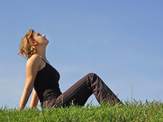 beautiful woman sitting in the grass - Powered by Adobe