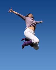 Fototapeta na wymiar young woman jumping high