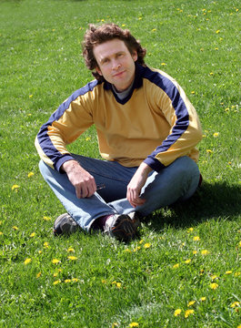 man sitting on grass