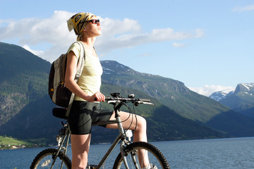 attractive woman on the bike in the mountains