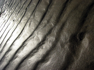 Fototapeta na wymiar cascade of sunlight across ripples in the sand