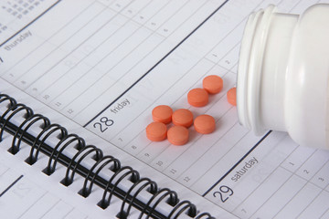 pills and bottle on appointment book