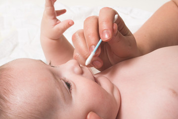 baby noze care with cotton swab