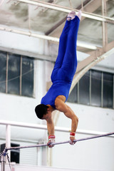 gymnast competing on high bar