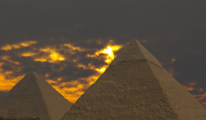 Obraz na płótnie Canvas pyramids under stormy sky