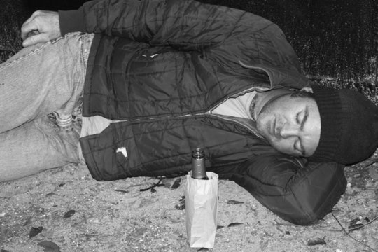 homeless man - sleeping on ground b&w