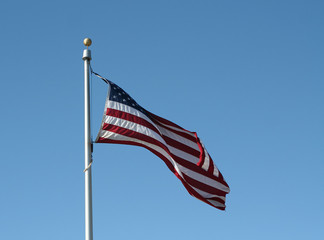 american flag against a blue sky