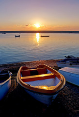 old rowing boats by sea during sunset