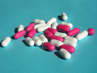 pink and white pills on bue