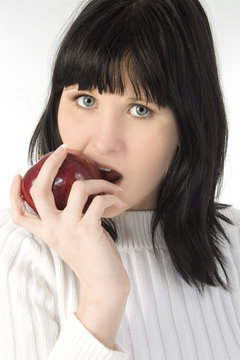 beautiful young woman eating apple