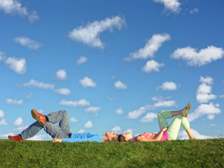 couple lies under clouds