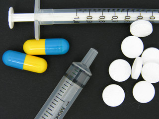 syringe and pills