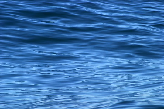 Fototapeta beautiful calm ripples on deep blue ocean on a bright sunny day