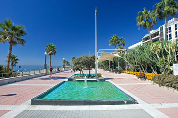sandy beach promenade and water fountains at estepona in souther