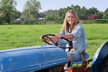 Fototapeta premium girl driving tractor