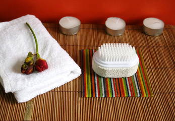 pumice brush, candles and towel at a spa - health and beauty