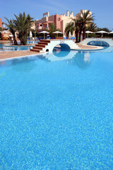 large, blue swimming pool in luxurious spanish complex